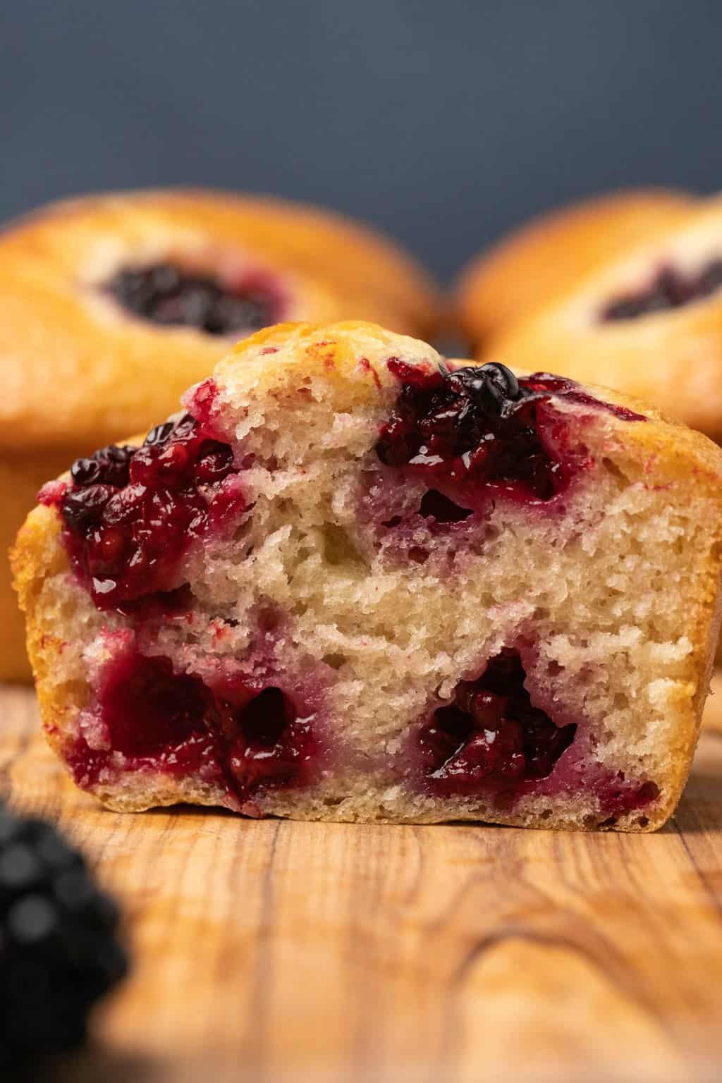 Vegan blackberry muffin cut in half to show the center. 