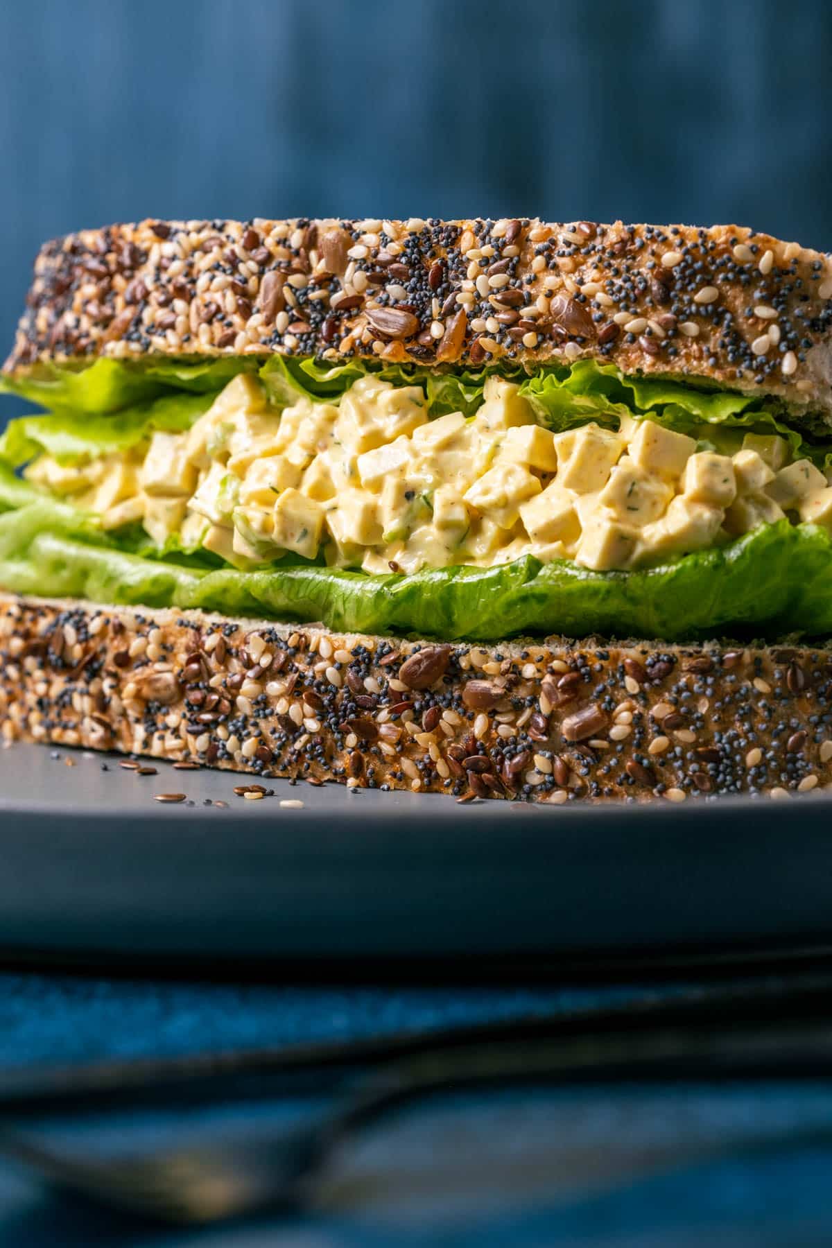 Vegan egg salad sandwich on a gray plate.