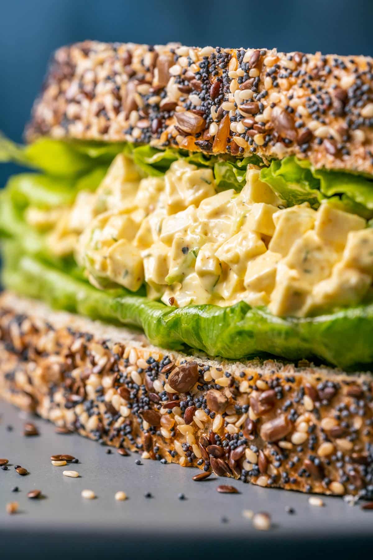 Vegan egg salad sandwich on a gray plate. 