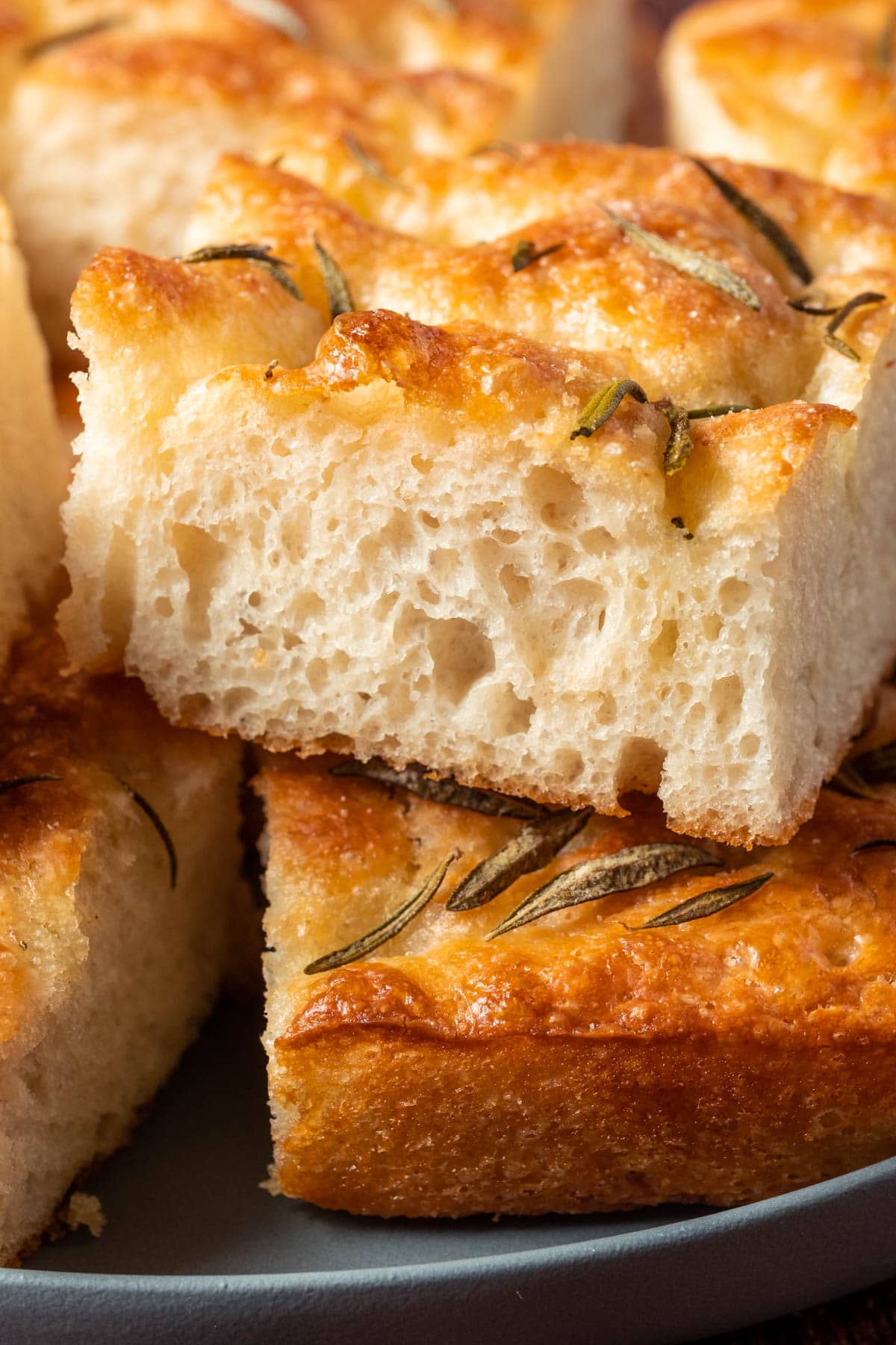 Vegan focaccia stacked up on a plate.