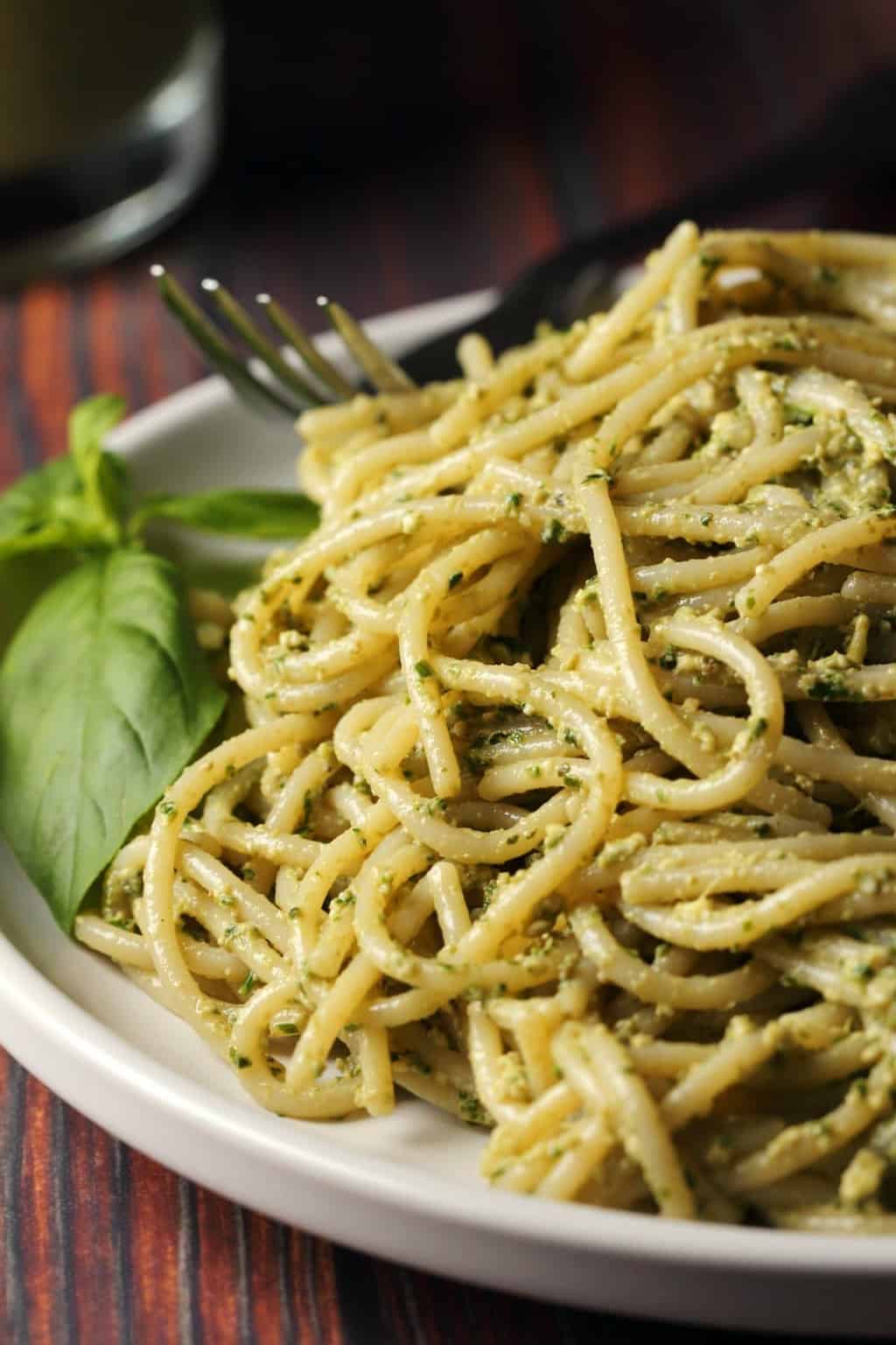 Vegan pesto with pasta on a white plate. 