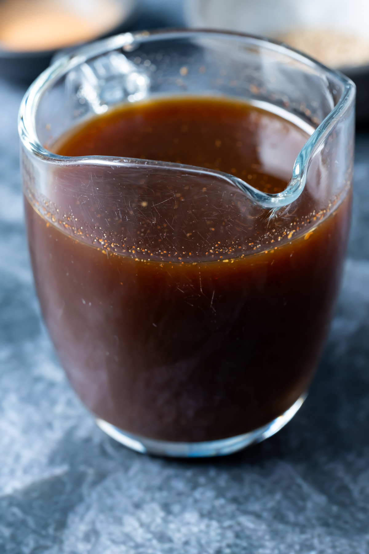 Vegan worcestershire sauce in a glass jug.